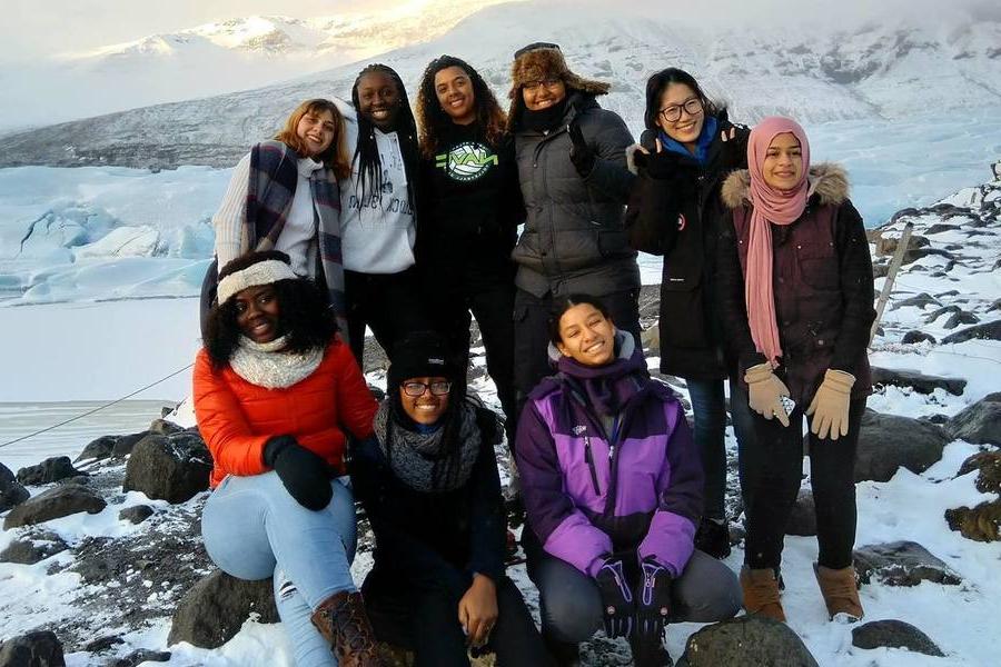 Students pose for group photo in a snowy landscape in Iceland.