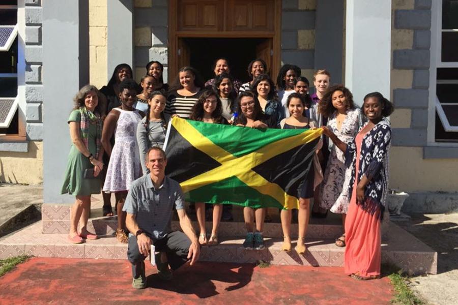 A group of students pose with the Jamaican flag.
